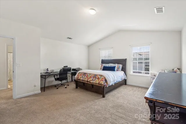 a spacious bedroom with a bed and a window