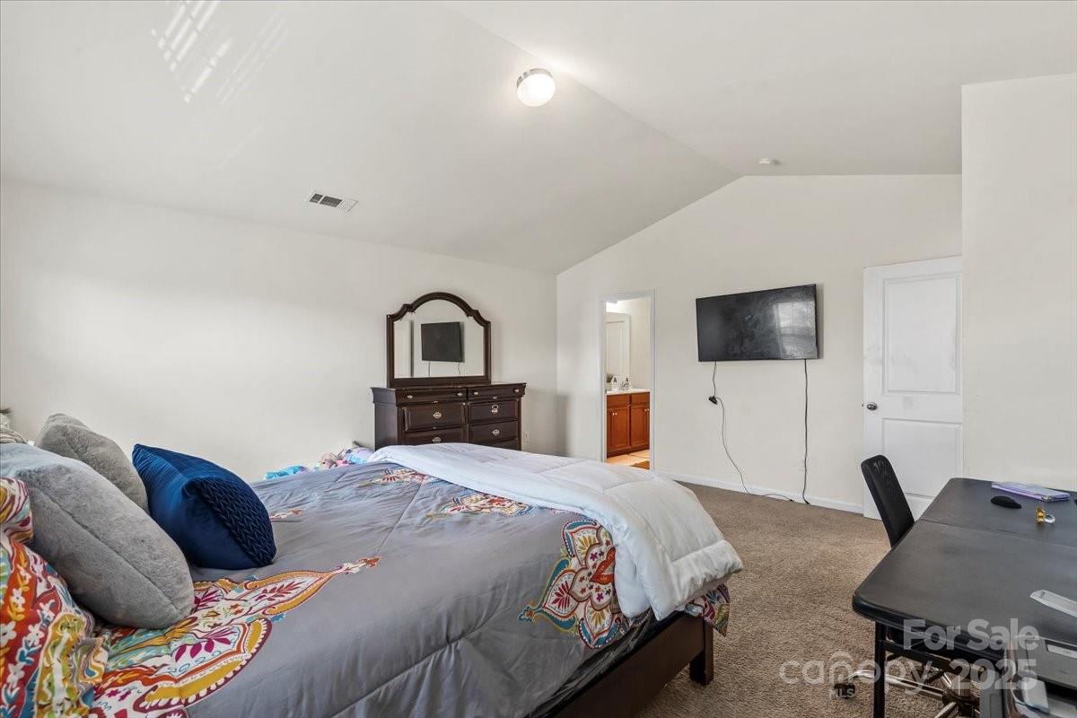 1848 Greenbrook Trail Dallas, NC 28034 - Photo 21 of 33 a bedroom with a bed and a flat screen tv