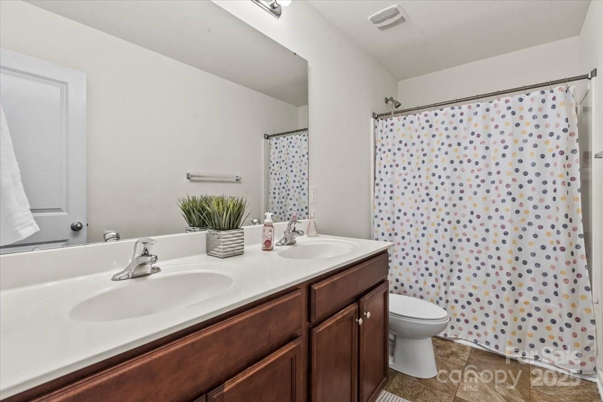 1848 Greenbrook Trail Dallas, NC 28034 - Photo 28 of 33 a bathroom with a granite countertop sink a toilet and a mirror