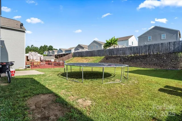 a swimming pool with outdoor seating and yard