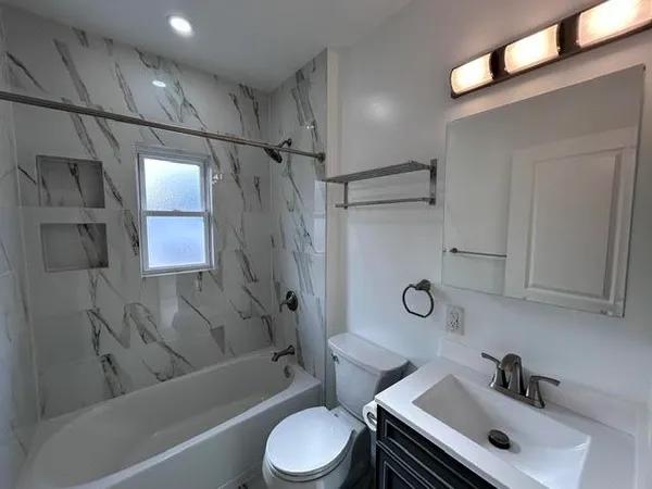 a bathroom with a sink toilet and shower