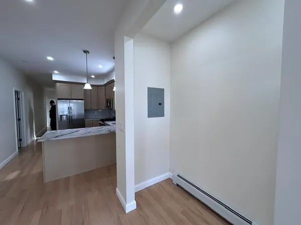 a view of kitchen with refrigerator and window
