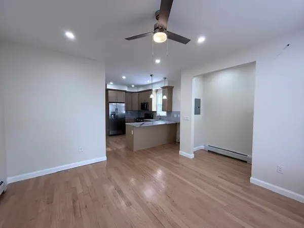 a view of a kitchen with a sink and a refrigerator