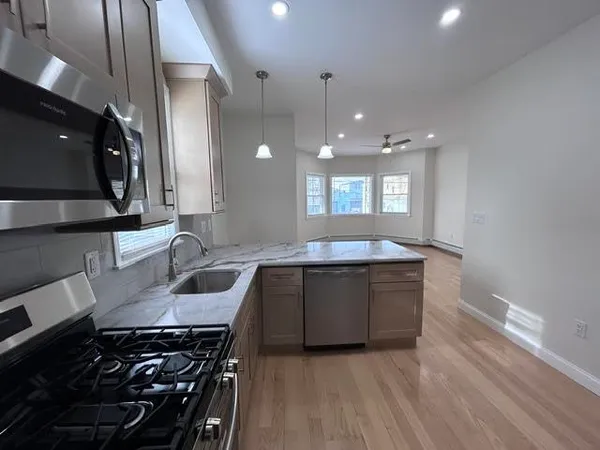 a kitchen with a sink stove and cabinets