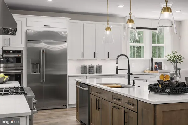 a kitchen with stainless steel appliances a sink stove and refrigerator