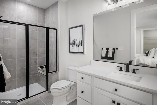 a bathroom with a toilet sink and a mirror