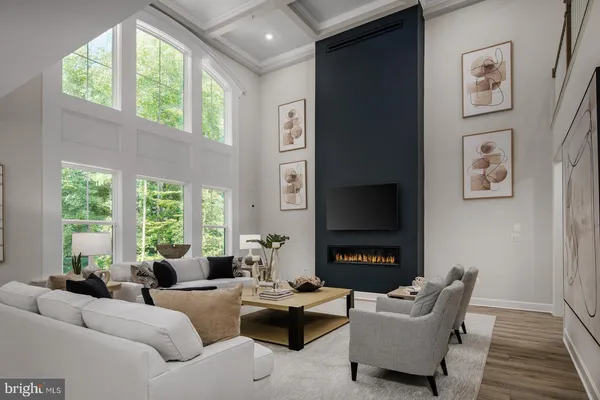 a living room with furniture a large window and a fireplace