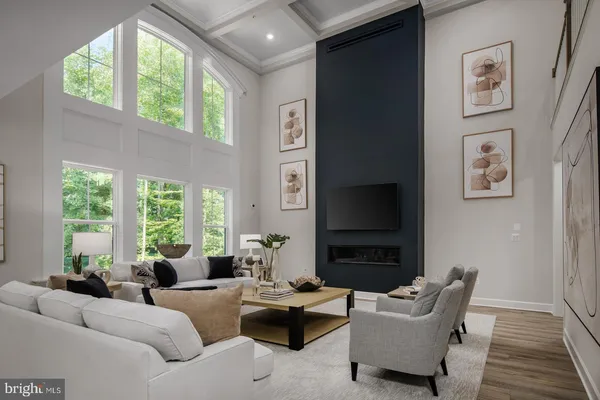 a living room with furniture windows and a flat screen tv