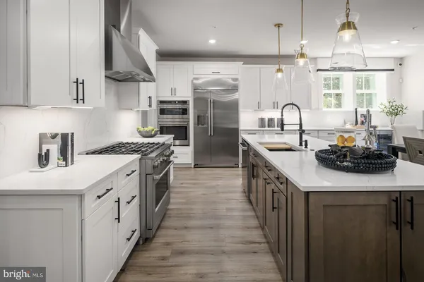 a kitchen with stainless steel appliances a sink stove and cabinets