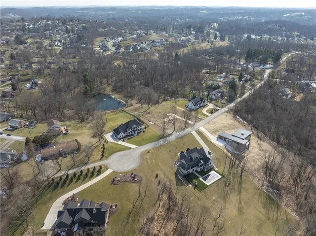 a view of a yard with snow on the road