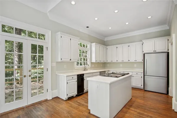 a kitchen with stainless steel appliances granite countertop a stove a refrigerator and a sink