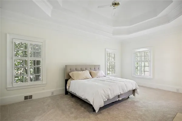 a bedroom with a bed lamp and window