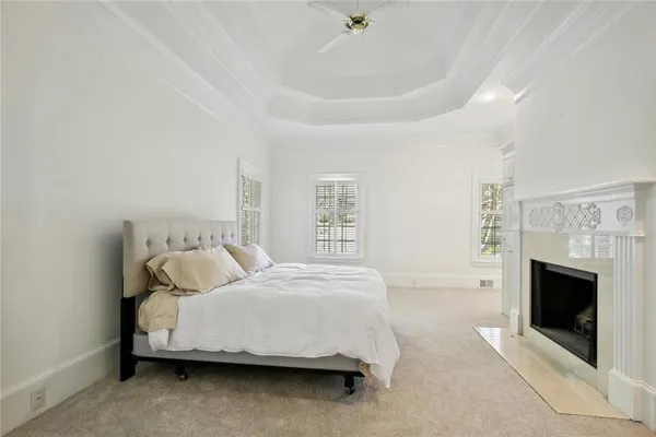 a bedroom with a bed and a fireplace