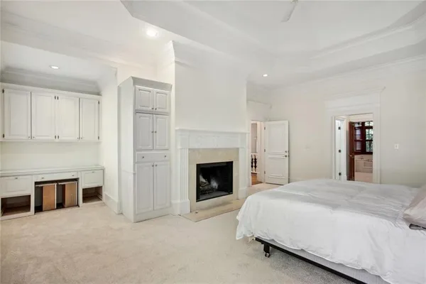 a spacious bedroom with a bed and a fireplace