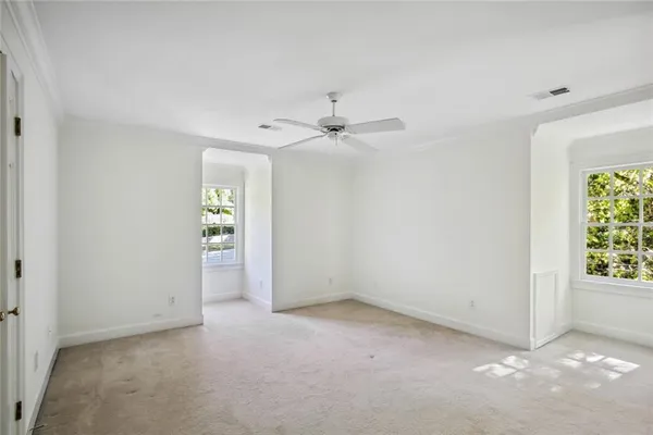 an empty room with windows and closet