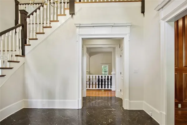 a view of a hallway with wooden floor and entryway