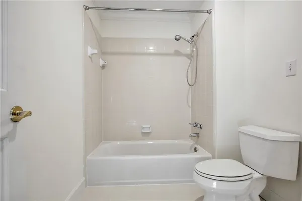 a bathroom with a toilet and a bathtub