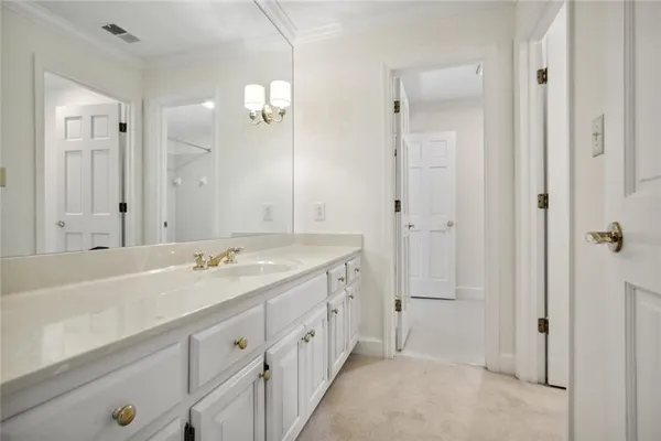a spacious bathroom with a double vanity sink a large mirror and shower