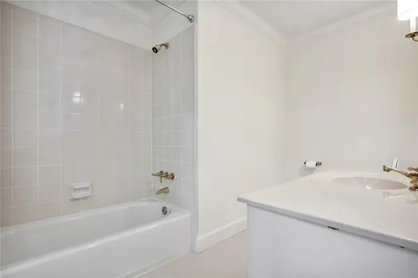 a bathroom with a tub sink and mirror