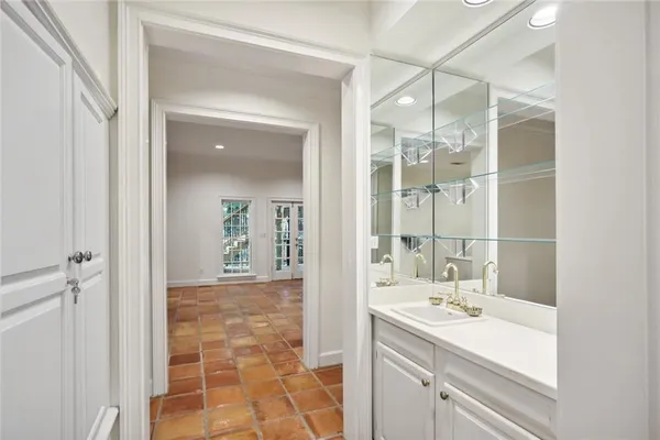 a bathroom with a sink shower and a mirror