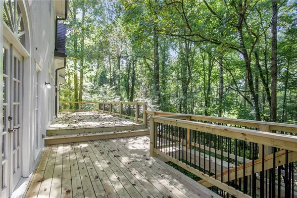 a view of a yard with wooden fence