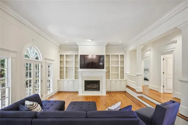 a living room with furniture fireplace and flat screen tv