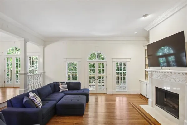 a living room with furniture a flat screen tv and a fireplace