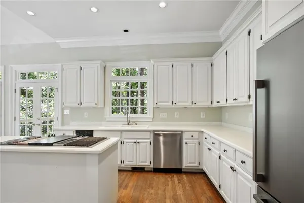 a kitchen that has a sink and a stove in it