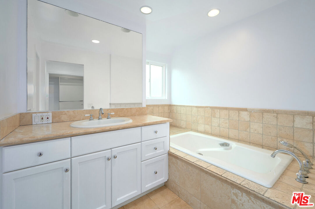 4250 Vía Dolce, Unit 321 Marina del Rey, CA 90292 - Photo 24 of 42 a bathroom with a tub sink and mirror