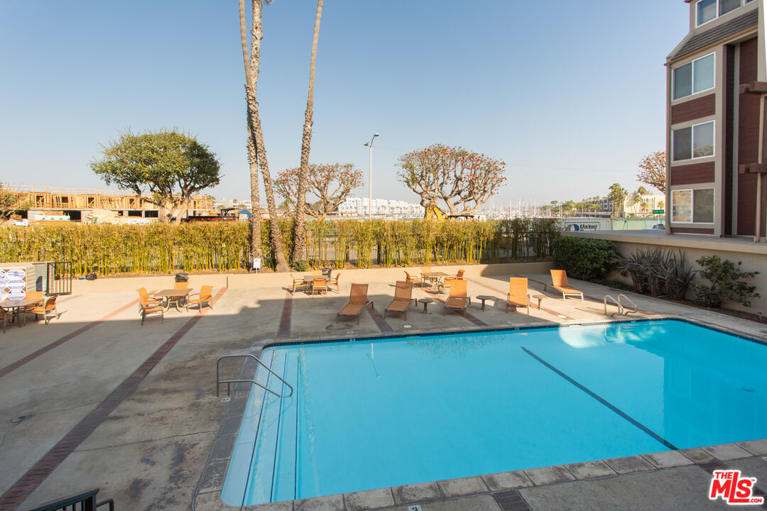 4250 Vía Dolce, Unit 321 Marina del Rey, CA 90292 - Photo 40 of 42 a view of a swimming pool with a lawn chairs