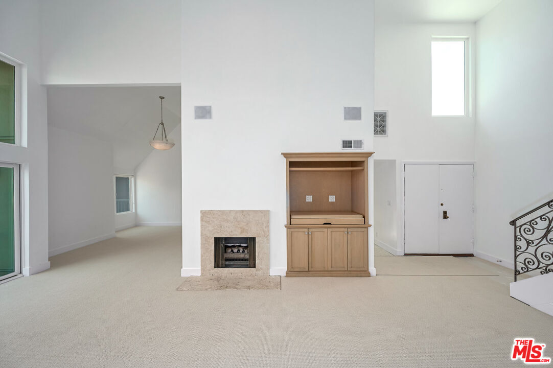 4250 Vía Dolce, Unit 321 Marina del Rey, CA 90292 - Photo 6 of 42 a view of an empty room with a fireplace and a window