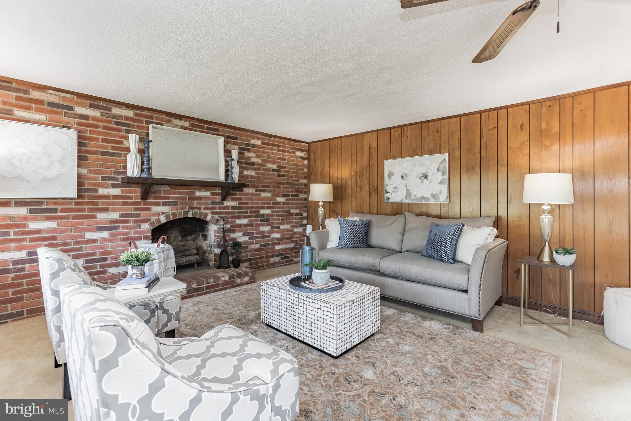 28814 Kemptown Road Damascus, MD 20872 - Photo 10 of 49 a living room with furniture a fireplace and a large window