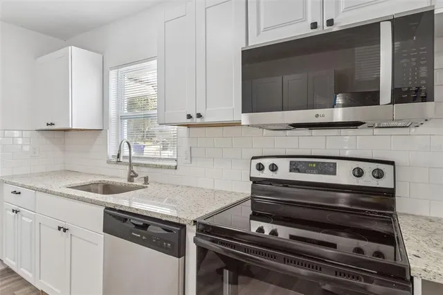 a kitchen with a stove and a sink