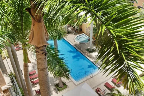 aerial view of a house with a yard and potted plants