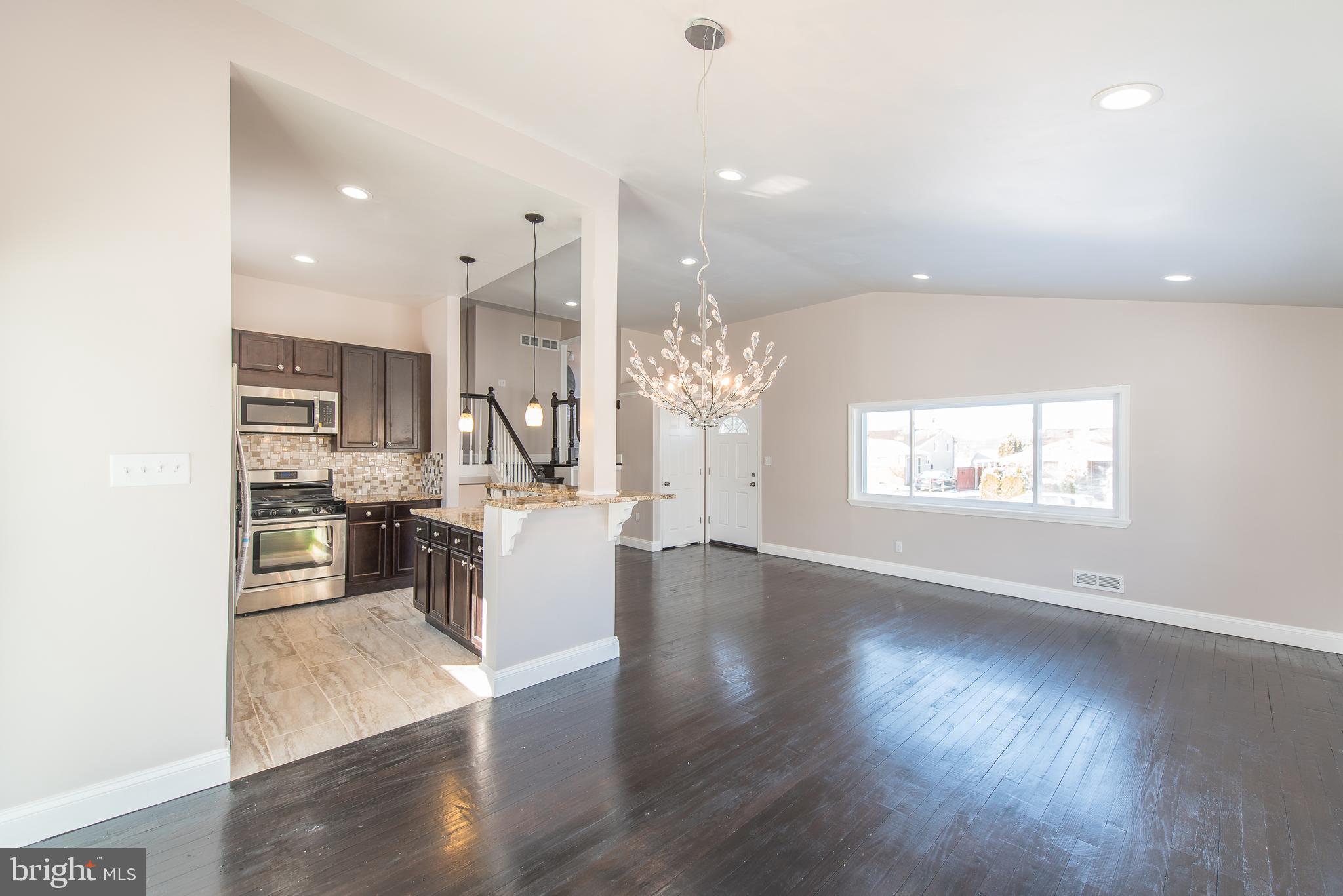 3327 Essex Road Baltimore, MD 21207 - Photo 12 of 35 a view of a kitchen with furniture and wooden floor