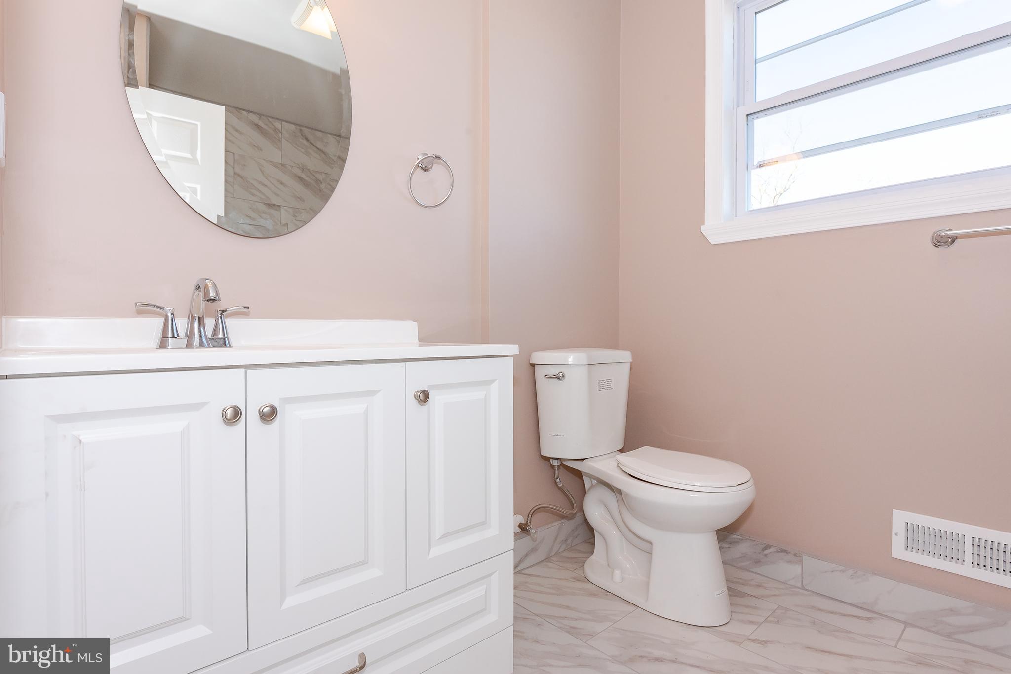 3327 Essex Road Baltimore, MD 21207 - Photo 18 of 35 a bathroom with a sink toilet and a mirror