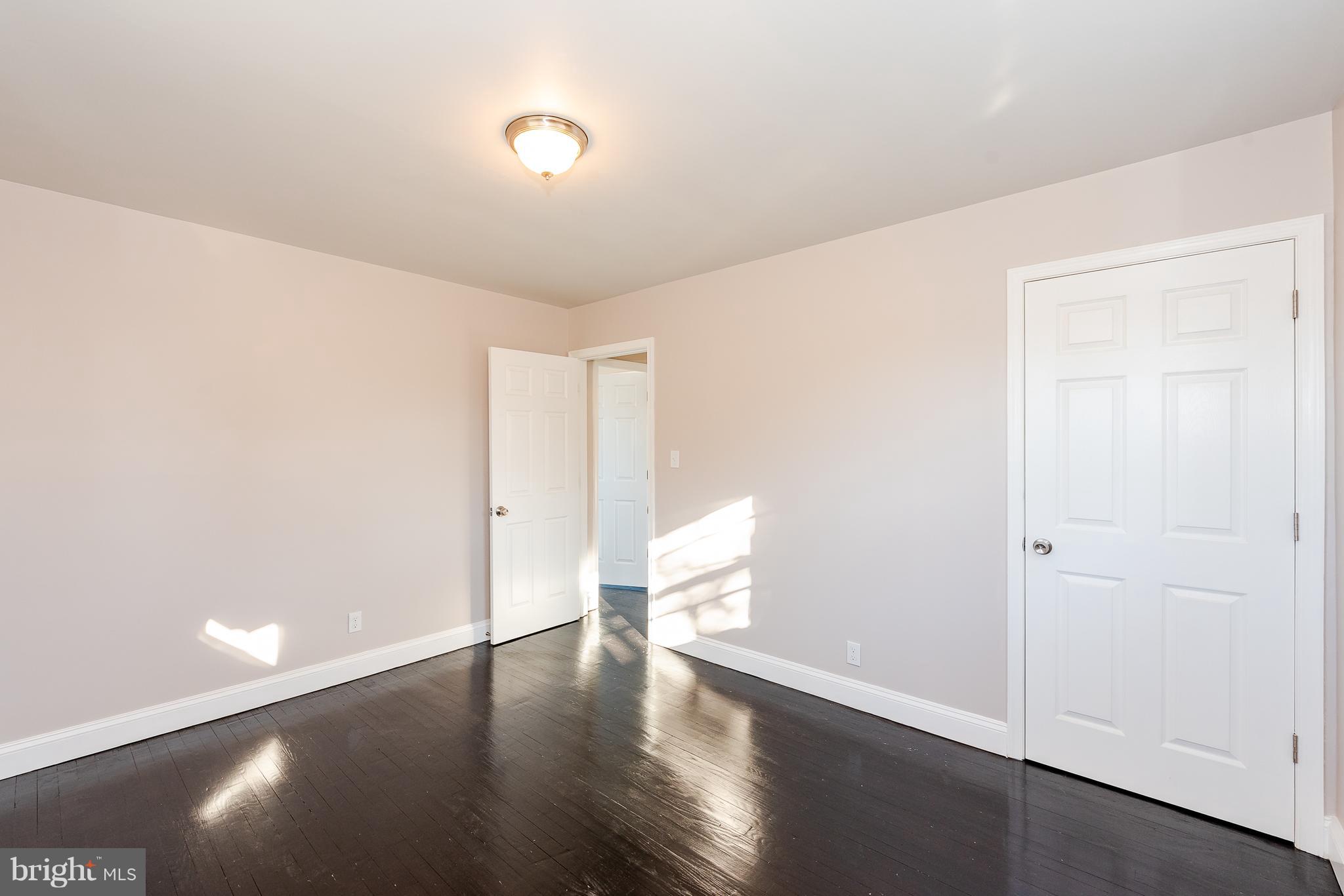 3327 Essex Road Baltimore, MD 21207 - Photo 22 of 35 a view of an empty room with wooden floor