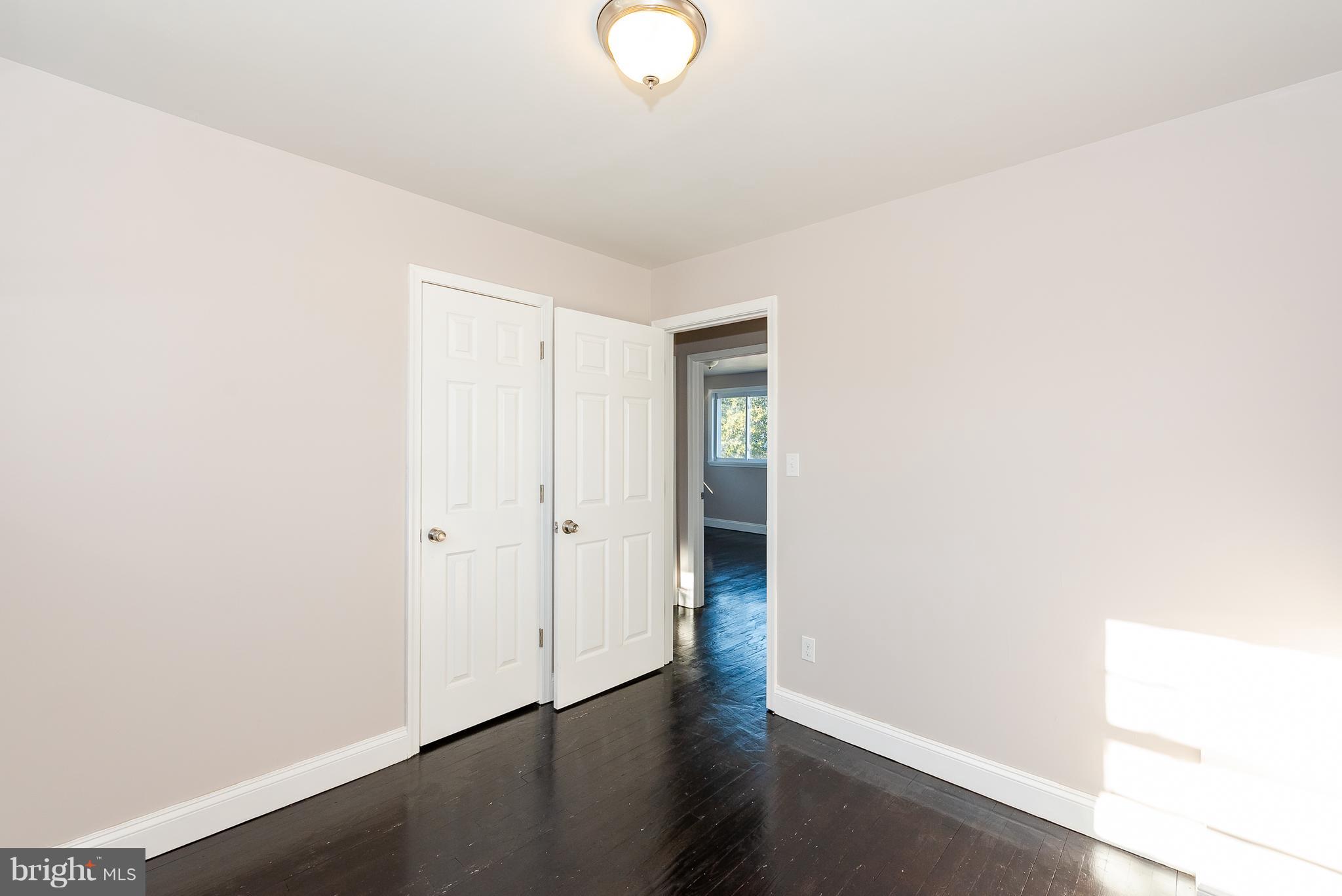 3327 Essex Road Baltimore, MD 21207 - Photo 24 of 35 a view of an empty room with wooden floor