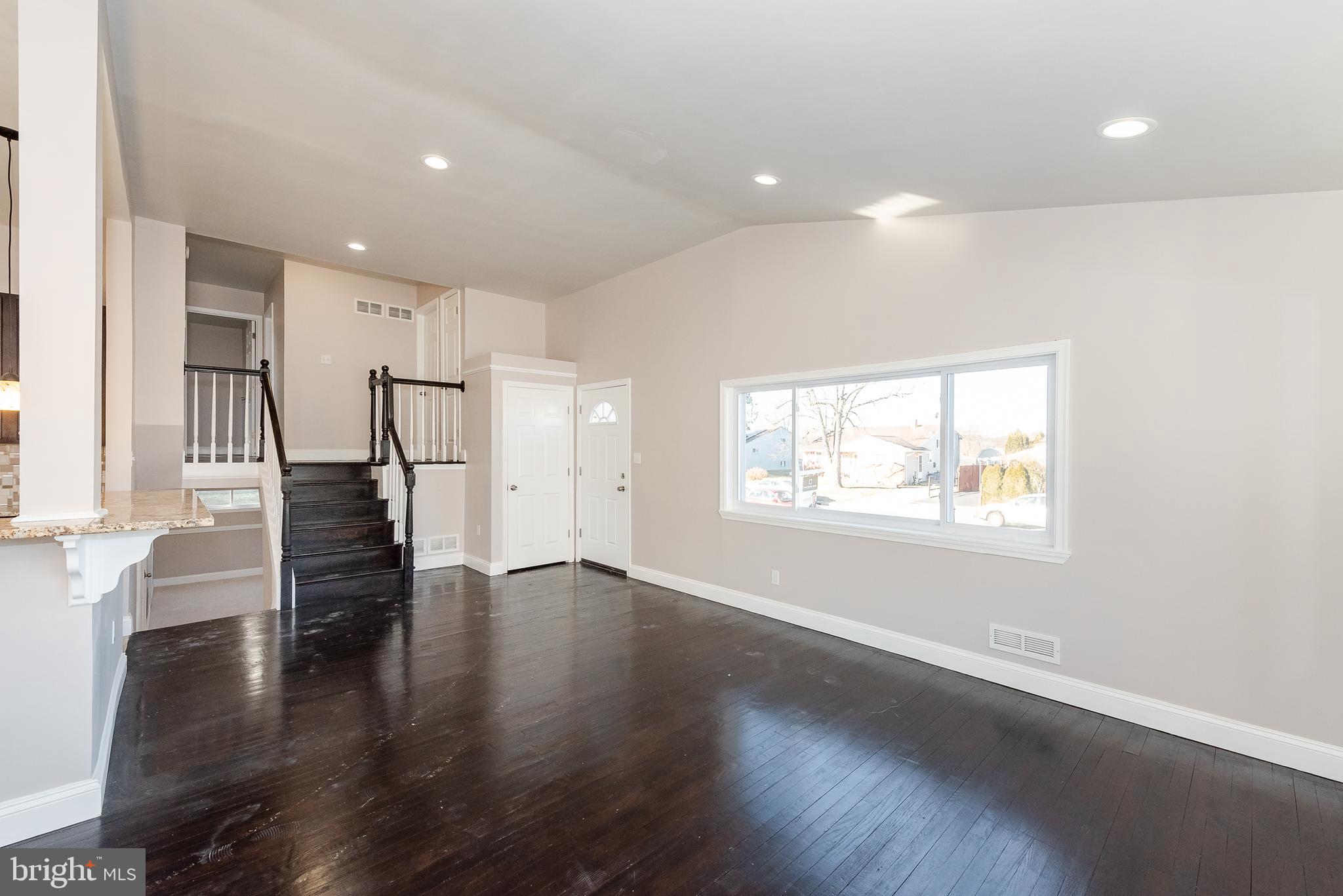 3327 Essex Road Baltimore, MD 21207 - Photo 4 of 35 an empty room with wooden floor and windows
