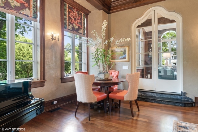 145 Oxford Road Kenilworth, IL 60043 - Photo 16 of 66 a dining room with furniture a floor to ceiling window and wooden floor