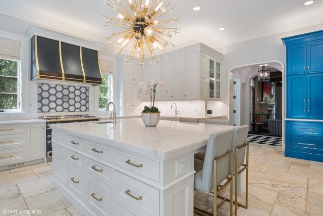 145 Oxford Road Kenilworth, IL 60043 - Photo 18 of 66 a dining hall with stainless steel appliances kitchen island granite countertop a table and chairs in it