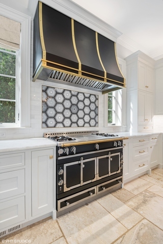 145 Oxford Road Kenilworth, IL 60043 - Photo 21 of 66 a kitchen with wooden cabinets and a stove top oven