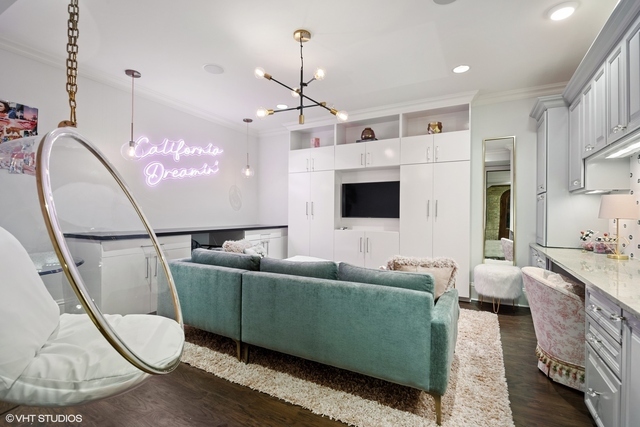 145 Oxford Road Kenilworth, IL 60043 - Photo 36 of 66 a living room with furniture a flat screen tv and a chandelier