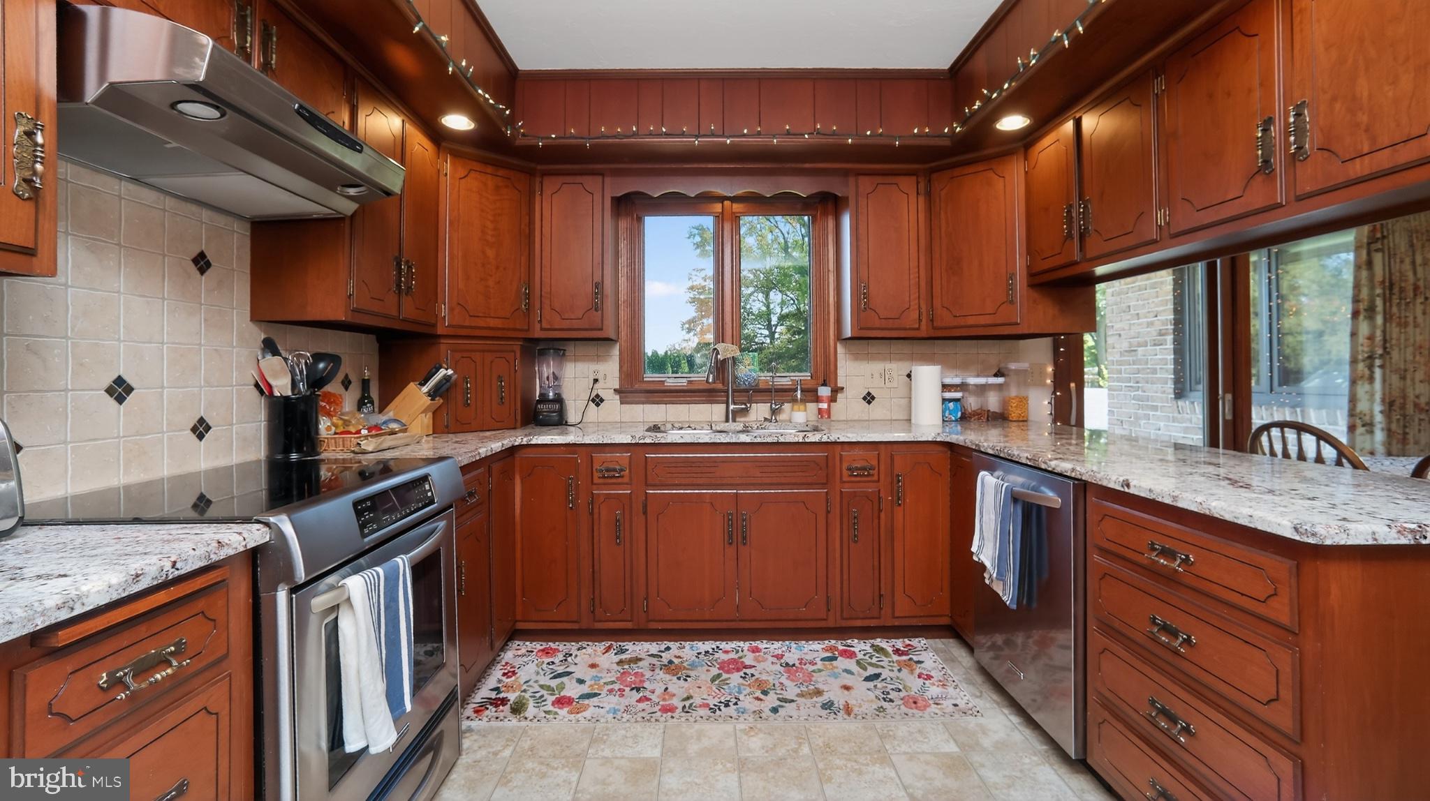 740 Lincoln Gardens Road Ephrata, PA 17522 - Photo 14 of 72 a kitchen with stainless steel appliances granite countertop a sink window and cabinets
