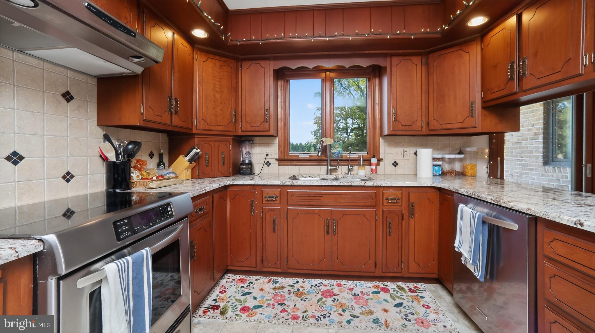 740 Lincoln Gardens Road Ephrata, PA 17522 - Photo 15 of 72 a kitchen with stainless steel appliances granite countertop a sink stove refrigerator and cabinets