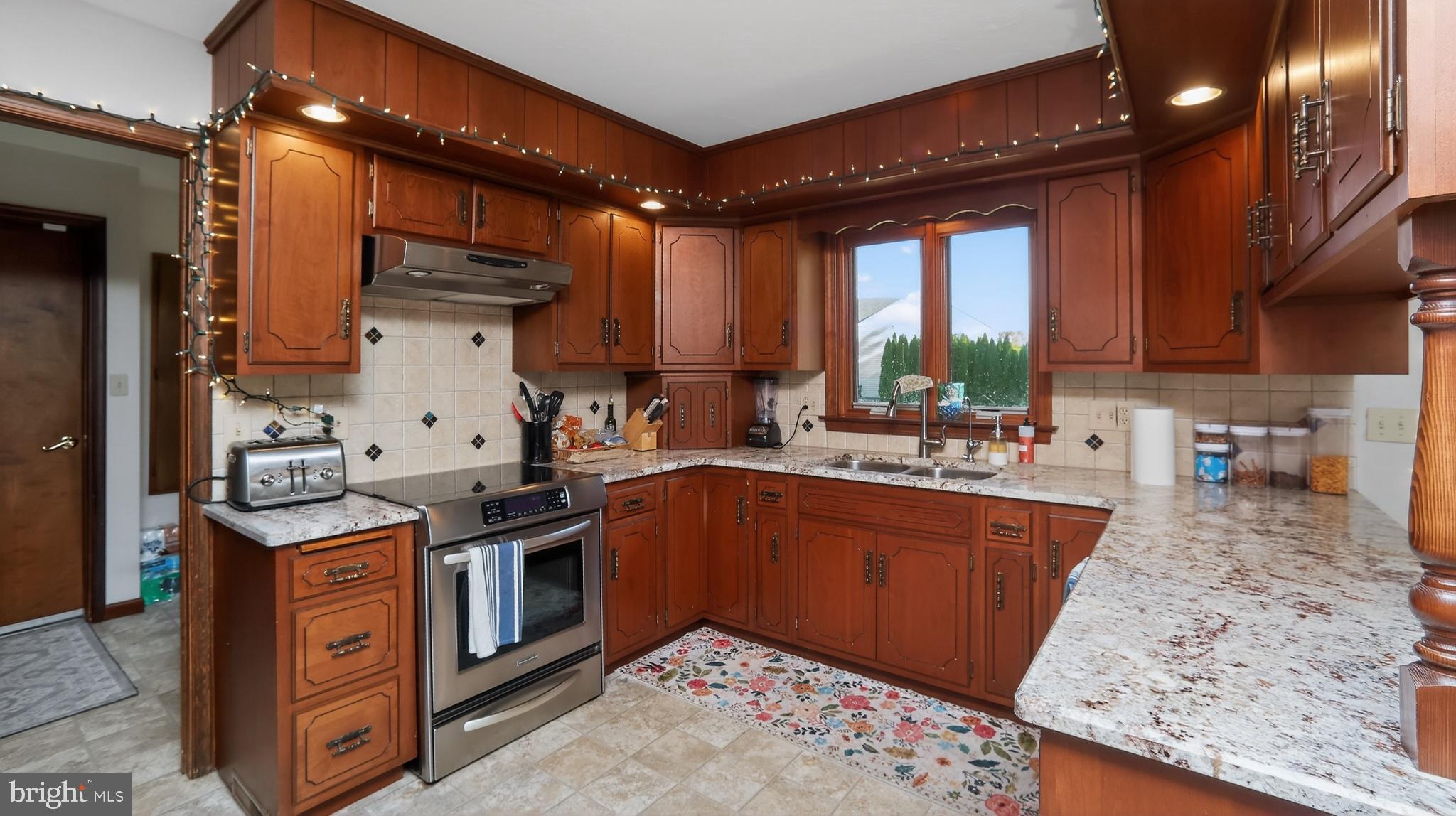 740 Lincoln Gardens Road Ephrata, PA 17522 - Photo 16 of 72 a kitchen with stainless steel appliances granite countertop a sink stove and refrigerator