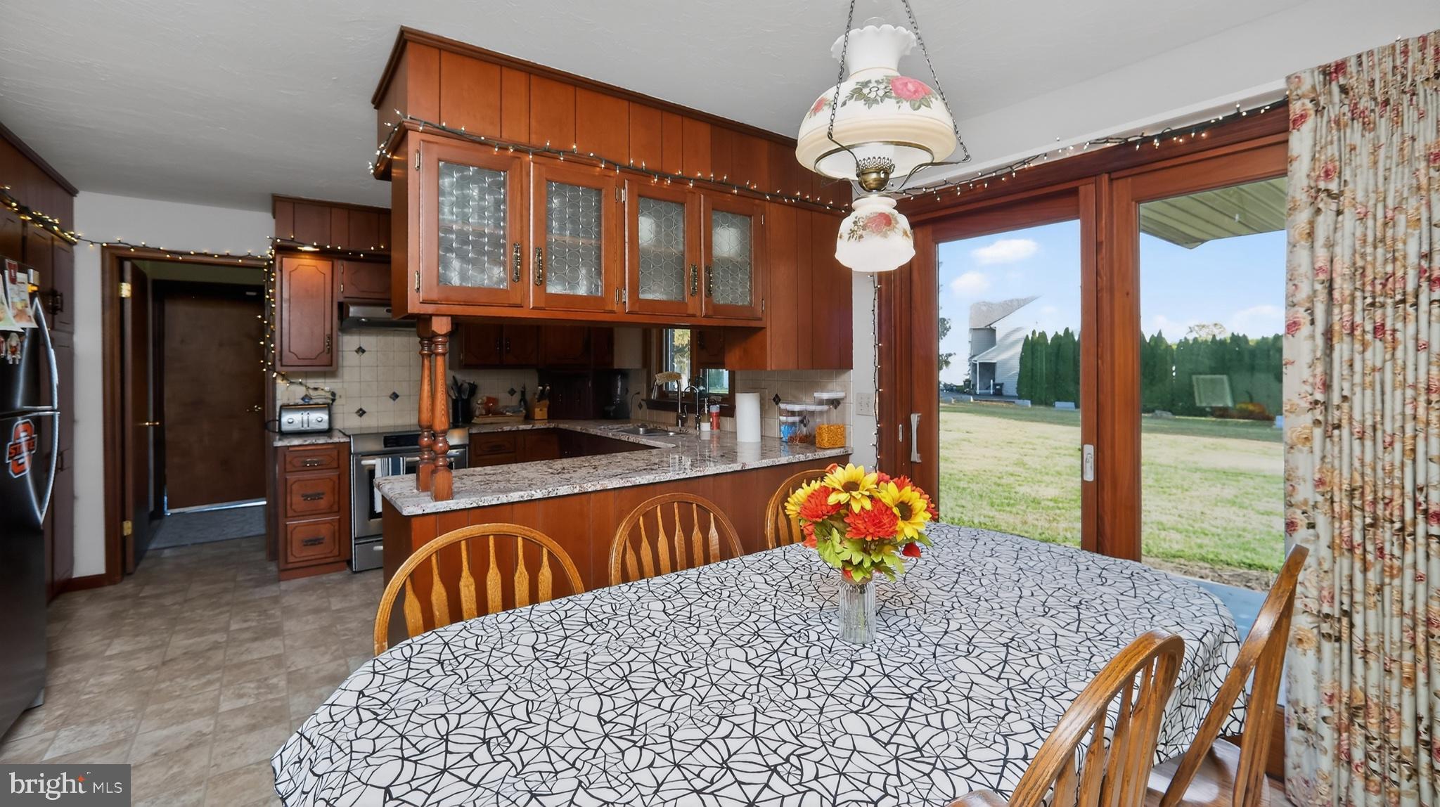 740 Lincoln Gardens Road Ephrata, PA 17522 - Photo 19 of 72 a living room with furniture a chandelier and a fireplace