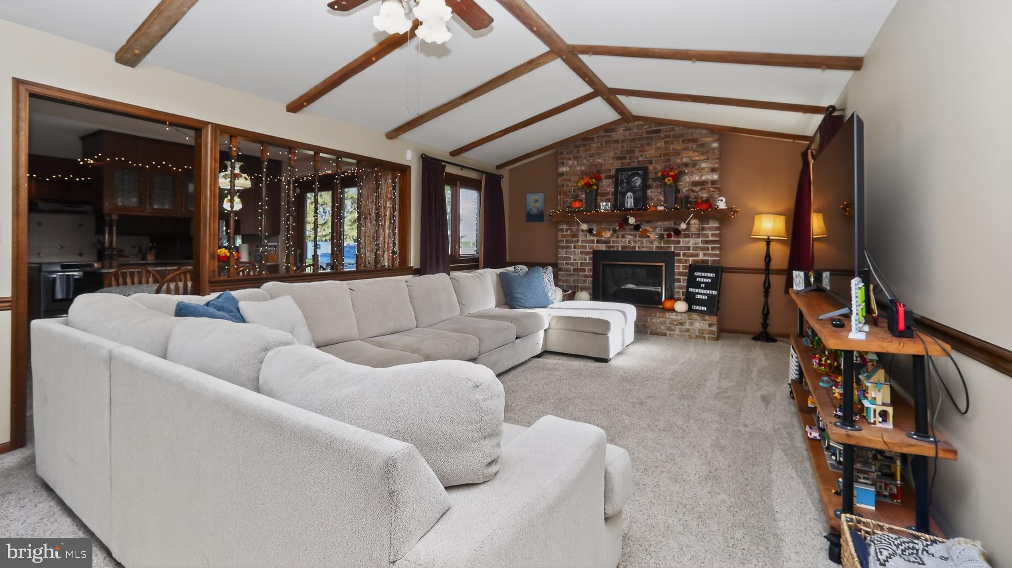 740 Lincoln Gardens Road Ephrata, PA 17522 - Photo 21 of 72 a living room with furniture a fireplace and a floor to ceiling window