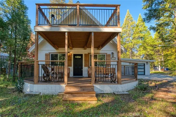a view of a house with entrance gate and garden