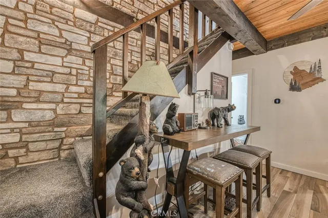 a kitchen with stainless steel appliances granite countertop a sink a stove a microwave oven and a window